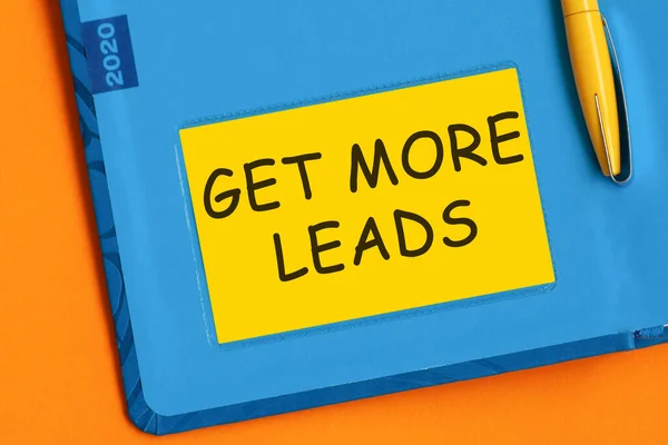 The word Get More Leads is written in marker on the yellow paper for notes.
