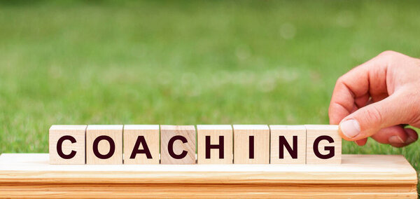 Слово "тренер" написано деревянными блоками. Концепция.