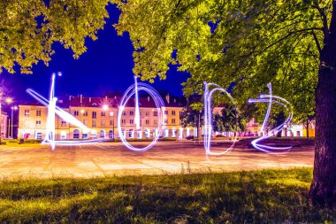 City of Lodz name drawn using light painting technique at night clipart