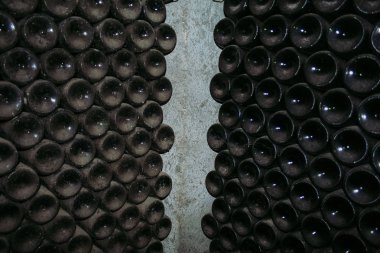 Şarap mahzeninde antika şarap şişeleri döşenmesi