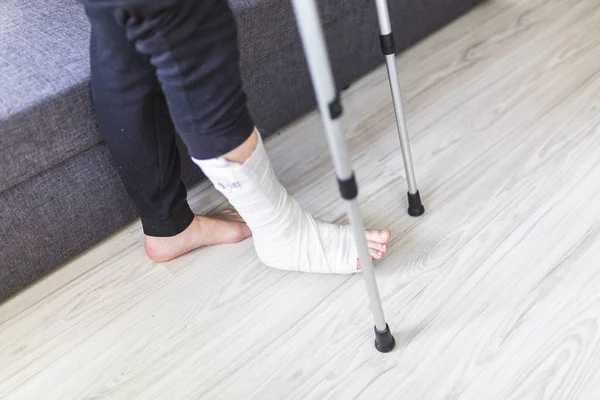 男性は骨折した足で歩いています。 — ストック写真