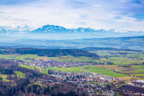 Panorama of alps and towns Wettswil, Stallikon and Bonstetten from odservation tower on Uetliberg mountain in Switzerland