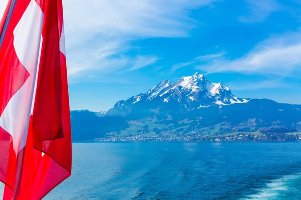 View of Pilatus Mountain and swiss flag from Lake Lucerne, Switzerland — Stock Photo, Image