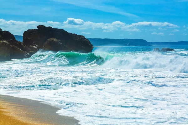 Wielkie fale uderzają w skały północnej plaży w mieście Nazare, Portugalia — Zdjęcie stockowe