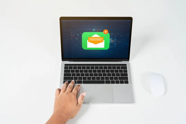 Person using a laptop computer with email communication connection message online and chat on social media with global letters concept. Laptop mockup with clipping path on screen.