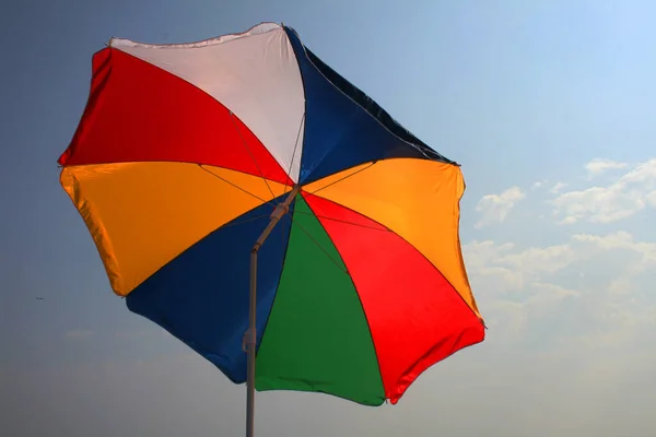 stock image a multicolored parasol on a beach