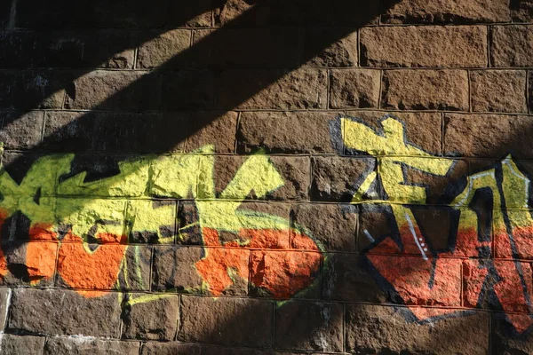 Graffiti drawings, different inscriptions on a brick wall, street art