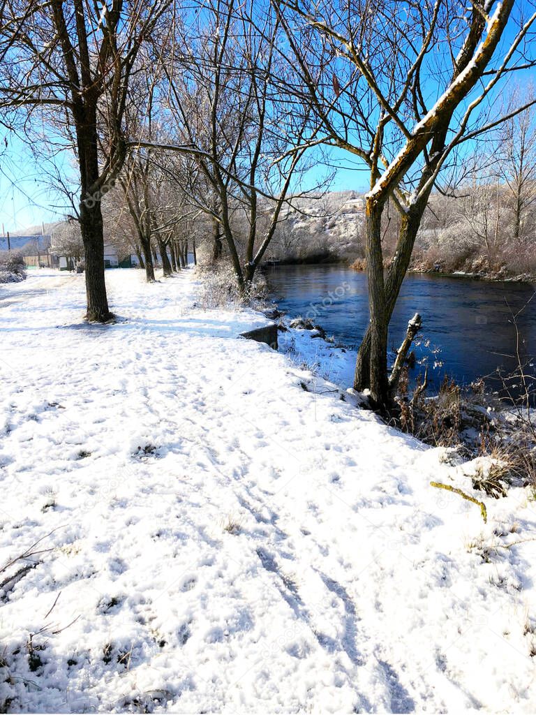 Snow on the bank of the river Carrion in the town of Guardo in the province of Palencia in Spain