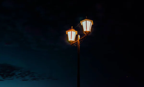 Old street lamp at night. The light of the street lantern