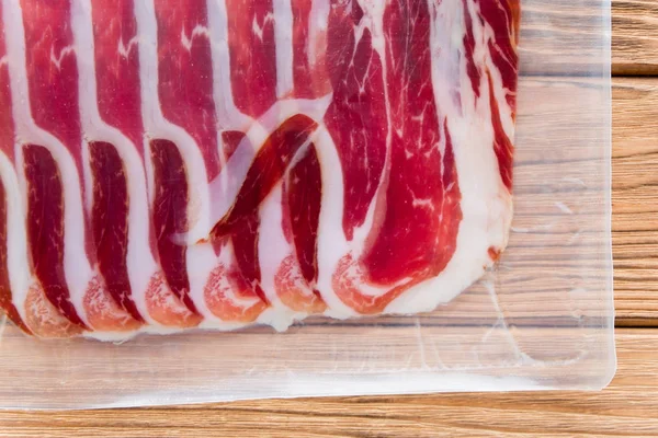 Jamon in a thin transparent package. Tasty meat