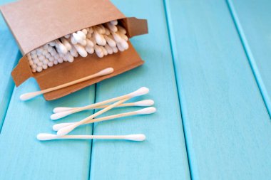 Turkuaz arka planda çevre dostu kozmetik çubuklar.