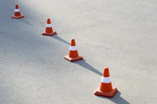 Four road cones on the pavement. Cast a shadow on the sun