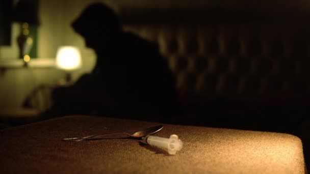 薬物中毒者は 投与量を適用した後 ベッドの上に座って 薬物を大量に注入されます — ストック動画
