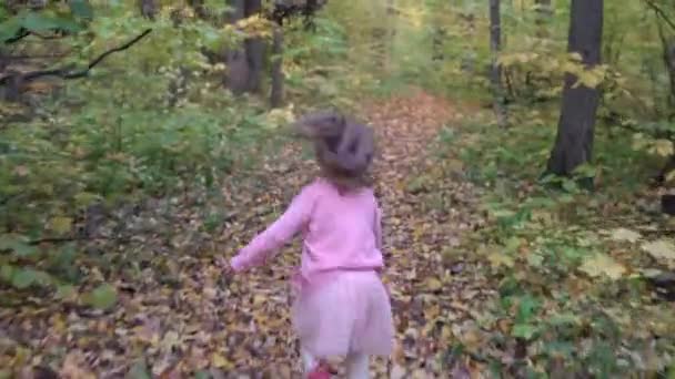 Fille au ralenti court le long du sentier dans la forêt d'automne — Video