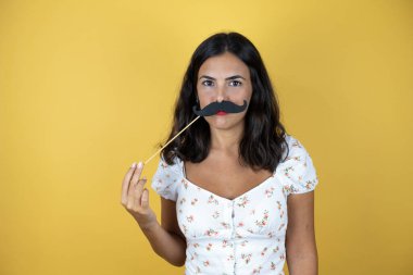 Sarı arka planda güzel bir kadın Bıyık maskesiyle mutlu