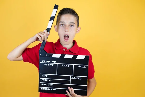 Young Beautiful Child Boy Isolated Yellow Background Holding Clapperboard Very — Stock Photo, Image