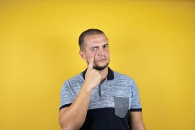 Rus adam sarı arka planda dikiliyordu. Gözünü dikip jestini izliyordu. Şüpheli bir ifadeydi.