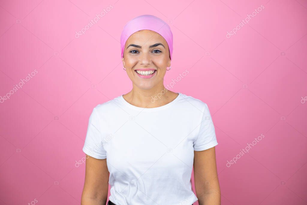 Young beautiful woman wearing pink headscarf over isolated pink background with a happy face standing and smiling with a confident smile showing teeth
