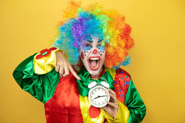 Clown Standing Yellow Insolated Yellow Background Surprised Holding Pointing Clock — Stock Photo, Image