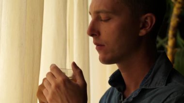 Üzgün Adam Çay İçiyor ve Pencereden Dışarı Bakıyor