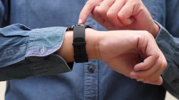 Чоловік у сорочці за допомогою смарт-годинника — стокове відео