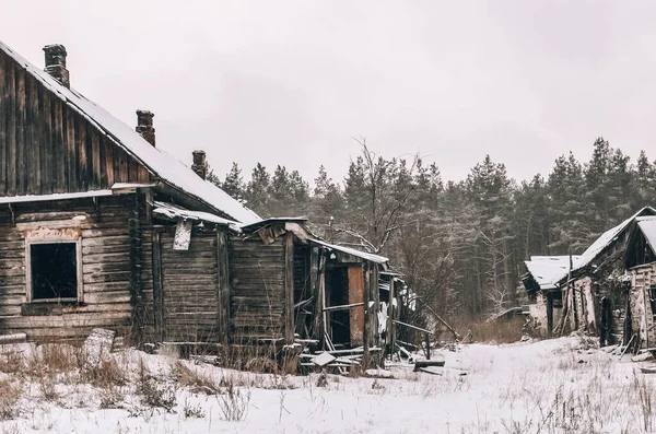 Harap olmuş eski ahşap bir ev. Eski bir evin kış fotoğrafı.