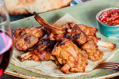 Kavrulmuş tavşan otlar, domates sosu ve şarap bir plaka üzerinde. Sıcak et yemekleri.