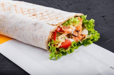 Börek fileto ızgara tavuk, marul, taze domates, turşu ve koyu ahşap zemin üzerine peynir dilimleri tamamladı. Sağlıklı yemek