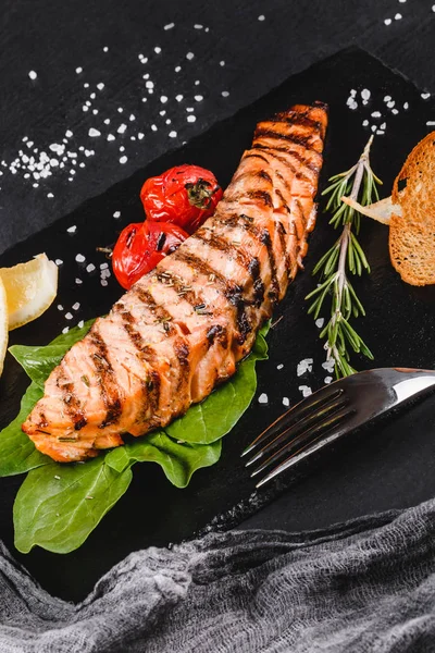 Grilled Salmon Fillet Garnished Spinach Lemon Herbs Stone Board Black — Stock Photo, Image