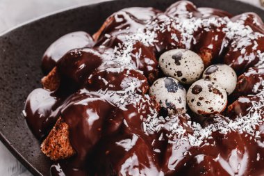 Paskalya kek çikolata, cevizli, bahar çiçekleri, Bıldırcın yumurta taş zemin üzerine. Mutlu Paskalya kutlamaları. Üstten Görünüm, düz yatıyordu