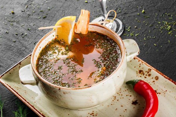 Fisksoppa med lax och räkor, dill, paprika, serveras med vodka på mörk sten bakgrund. Uppifrån och. — Stockfoto