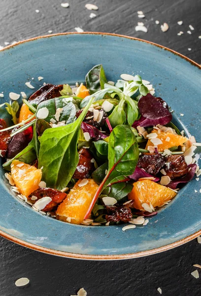 Salat mit Leber, Rucola, Orange, Spinat und Mandeln auf Teller — Stockfoto