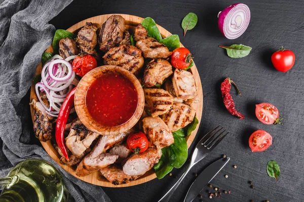 Assorted delicious grilled meat and sausages with tomatoes and b Stock Photo
