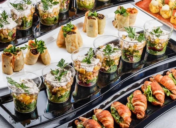 Mini appetizers with salmon fish, caviar, cheese, prawn, shrimp and greens on banquet table. Gourmet food close up, snack, antipasti, Seafood platter — Stock Photo, Image