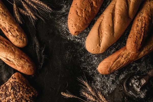 Variety Delicious Breads Buns Dark Slate Background Wheat Spikiletes Sackcloth — Stock Photo, Image