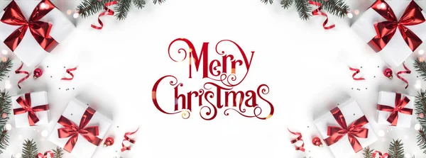 ギフトボックス リボン 赤い装飾 モミの枝 輝きとコンフェッティと白い背景にメリークリスマステキスト クリスマスと新年の挨拶カード フラットレイアウト トップビュー — ストック写真