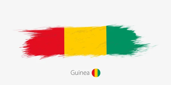 几内亚的旗子 垃圾抽象画笔冲程在灰色背景 矢量插图 — 图库矢量图片