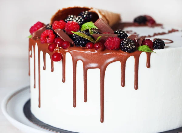 Festive cake with chocolate and berries in a waffle horn — Stock Photo, Image