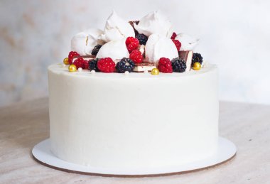 White festive cake with meringue and berries clipart