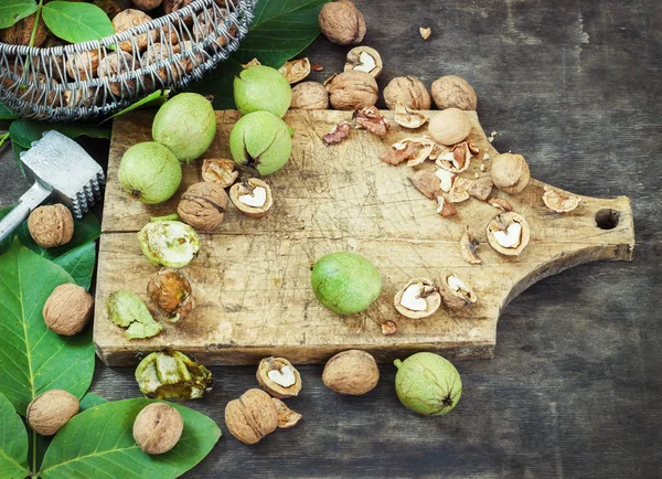 Whole Walnuts and Cleared Black Wooden Background Top view Healthy concept — Stock Photo, Image