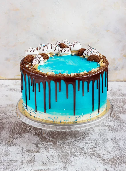 Blue cream cake in a marine style on a light backgroundwith chocolate