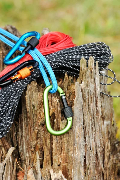 Metal carabine and rope for mountaineering. Photo of colored carabines and rope. Climbing concept