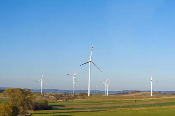 Wind turbines generating electricity. Electrical windmills.