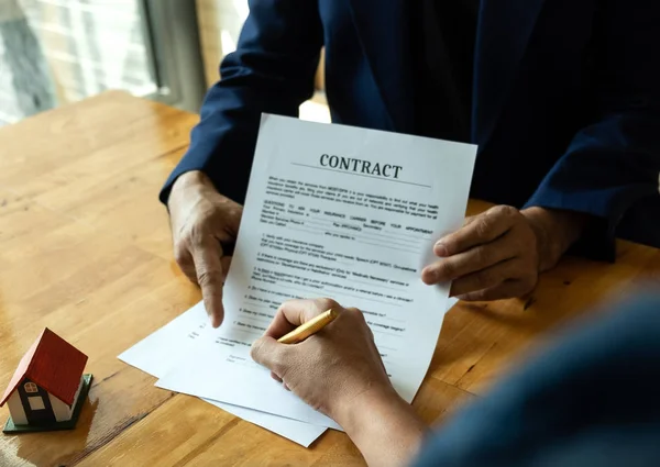 Businessmen point to documents for customers to sign.Signing documents after the business agreement,Business concepts.