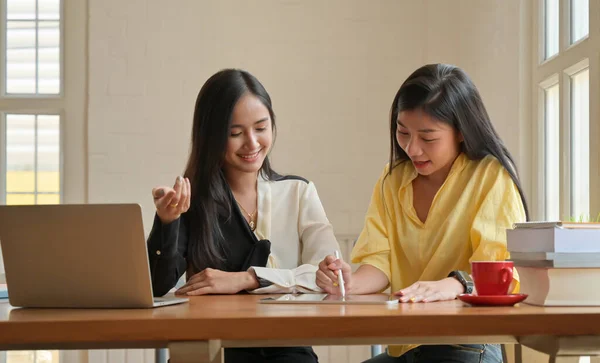 二人のアジアの女性が彼女の家で笑顔でタブレットを使用しています — ストック写真