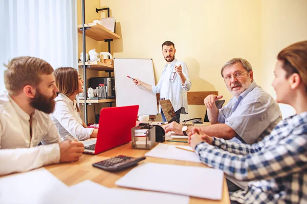 Team job. Photo young businessmans working with new project in office — Stock Photo, Image