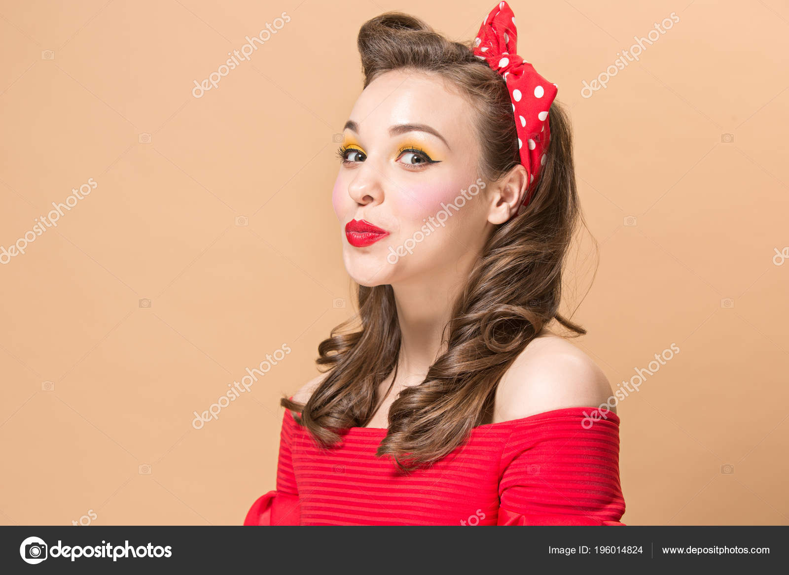 Beautiful Young Woman With Pinup Make Up And Hairstyle Studio