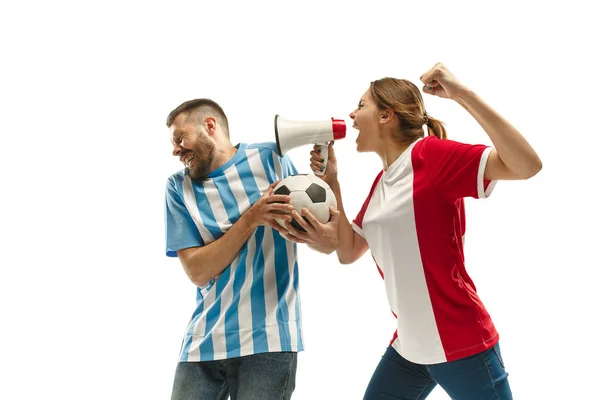 The unhappy and sad Argentinean fan on white background. The young man in soccer football uniform and girl at white studio. Fan, support concept. Human emotions concept.