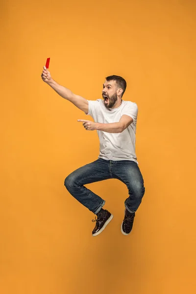 Voetbal supporter met rode kaart op een oranje achtergrond — Stockfoto