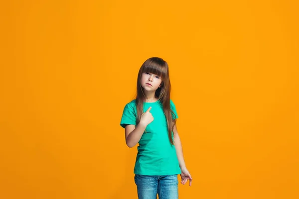 Beautiful female half-length portrait on orange studio backgroud. The young emotional teen girl — Stock Photo, Image